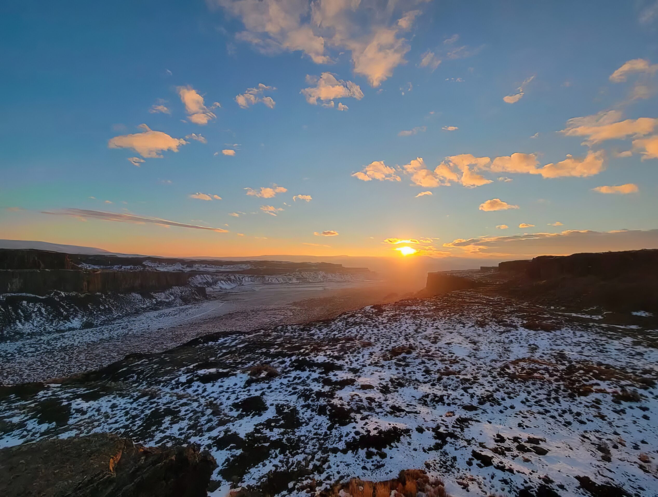 Frenchman Coulee with snow and sun setting on the horizon