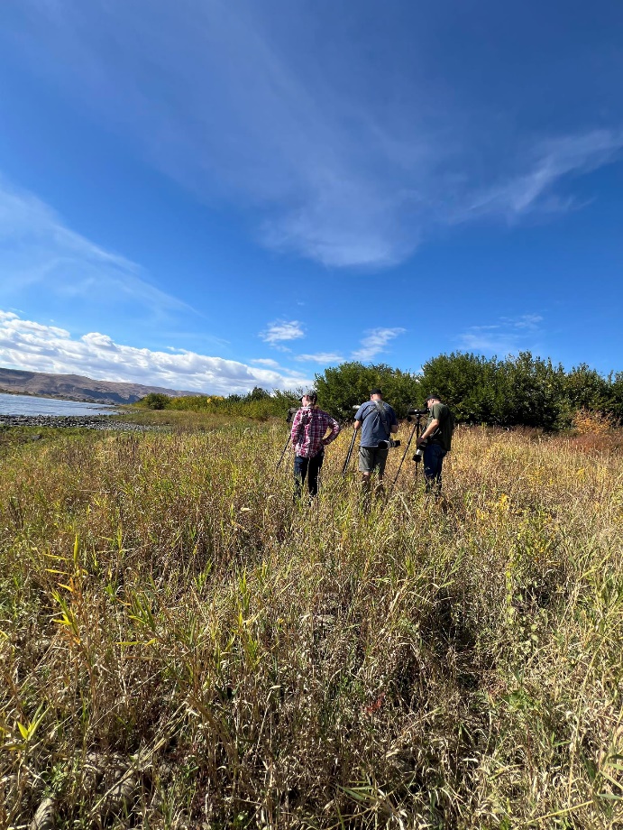 People setting up a tripod